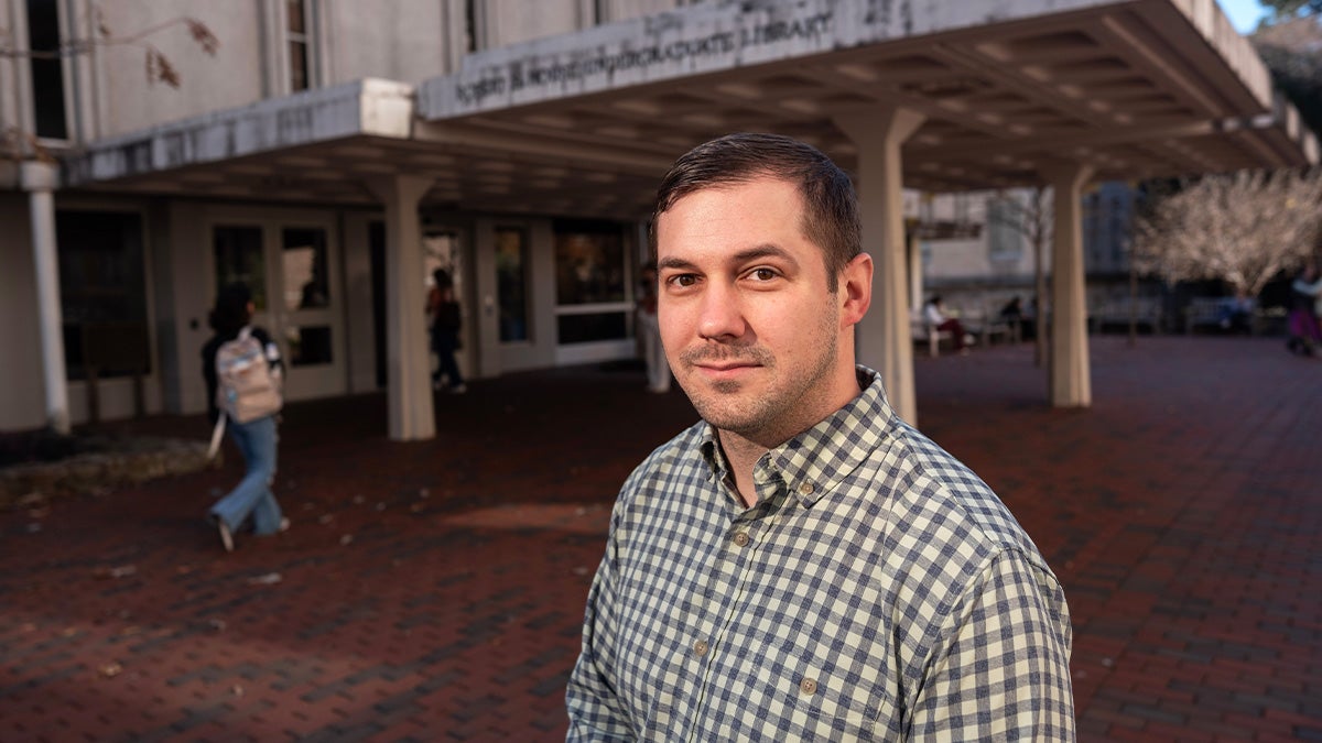 Portrait of Jesse Bethany standing outside the Robert B. House Undergraduate Library on the campus of UNC-Chapel Hill.