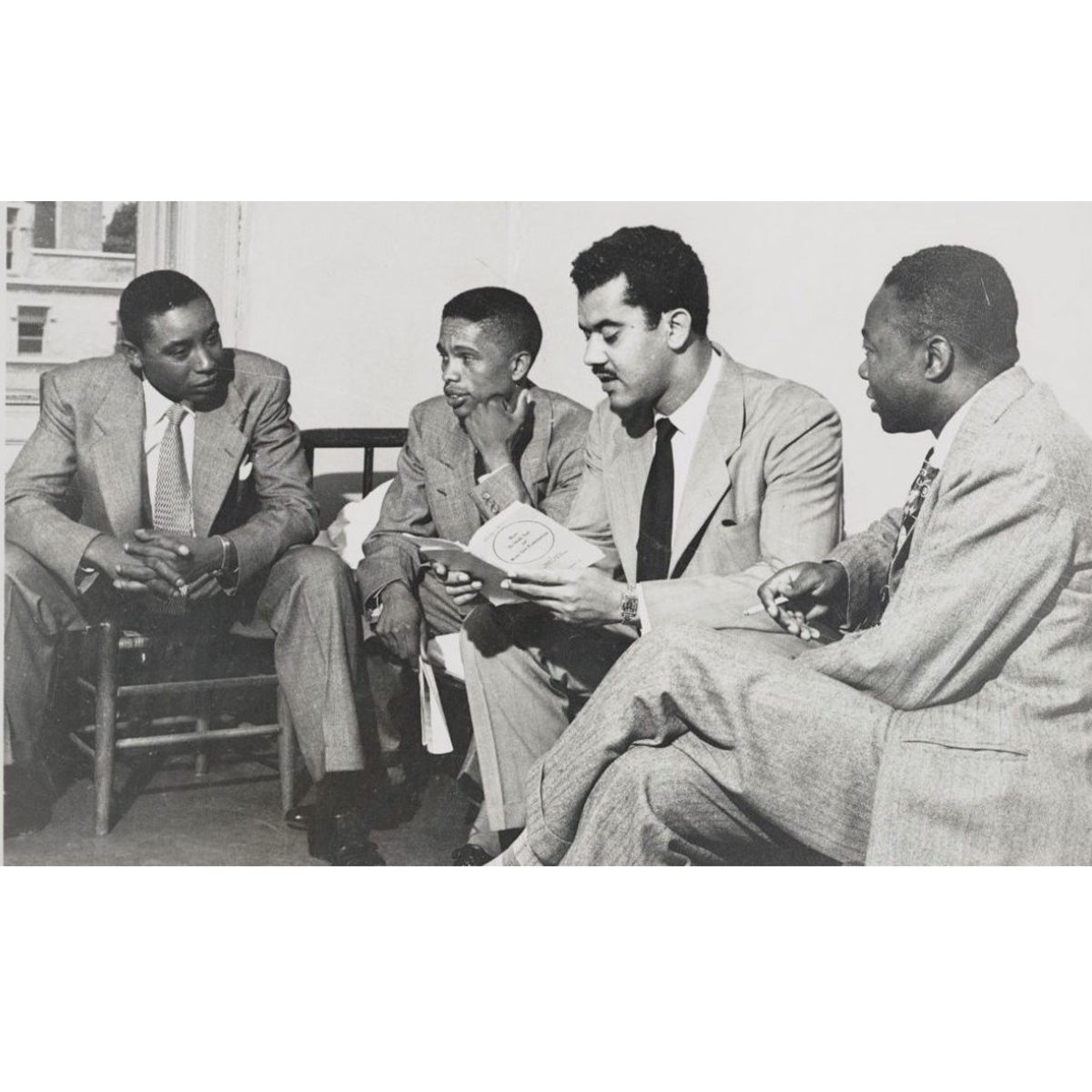 Four students sitting and talking to each other.