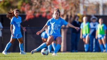 Ally Sentor kicking soccer ball on field.