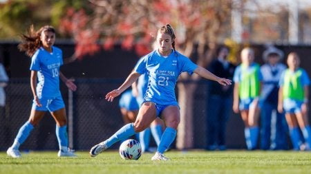 Ally Sentor kicking soccer ball on field.
