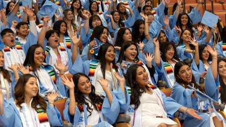 Graduates waving hands in the hair