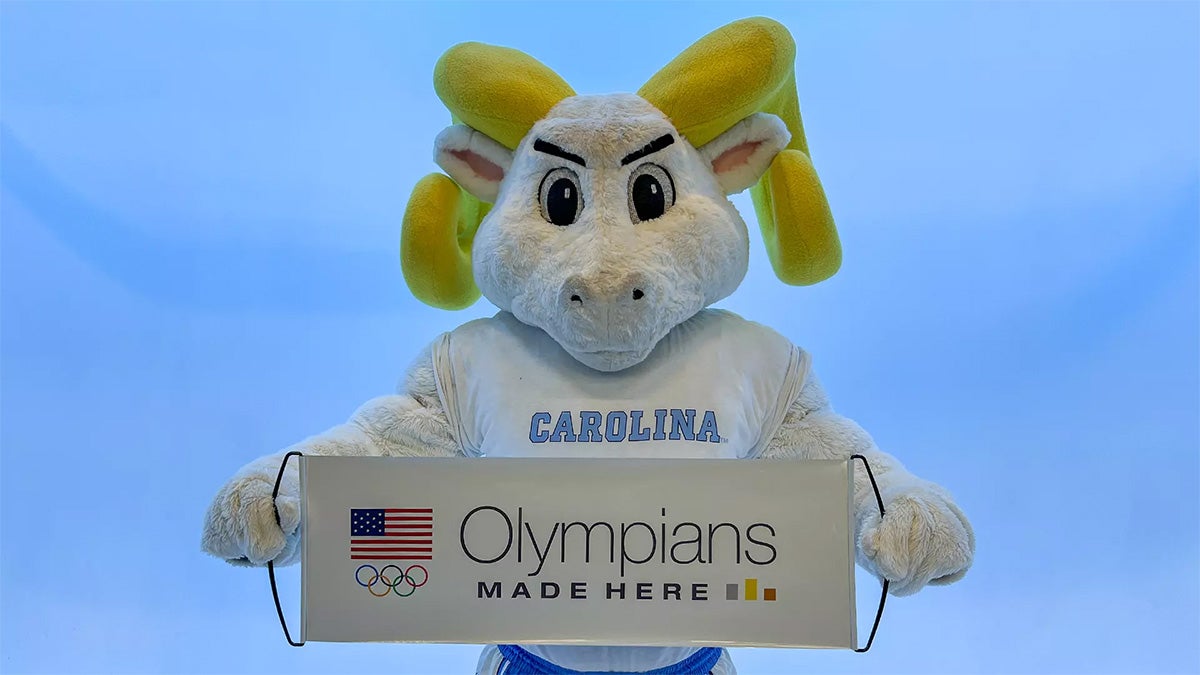 Rameses holding Olympics banner