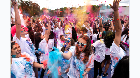 Large crowd of UNC-Chapel Hill at Holi Moli, a festival of colors, covered in paint.