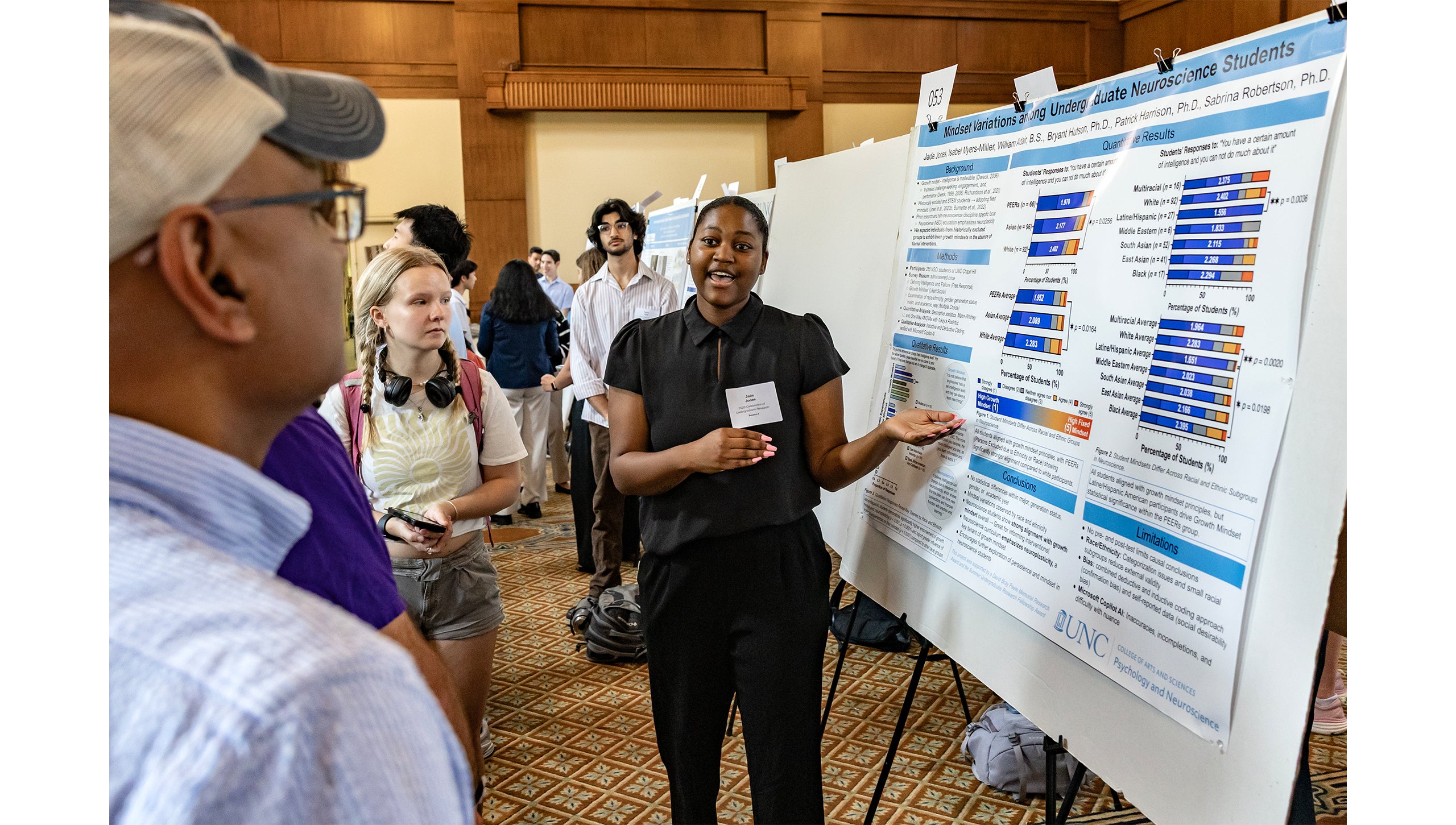 A student explains parts of her research to attendees of the Celebration of Undergraduate Research