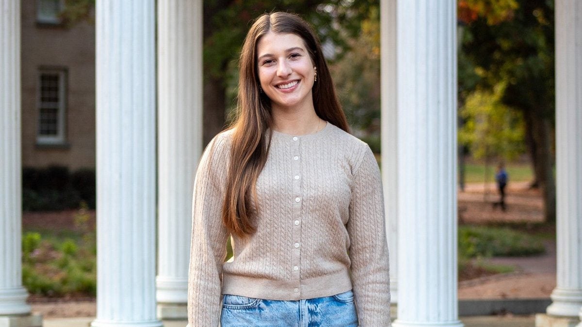 Elizabeth Kohn standing in front of Old Well.