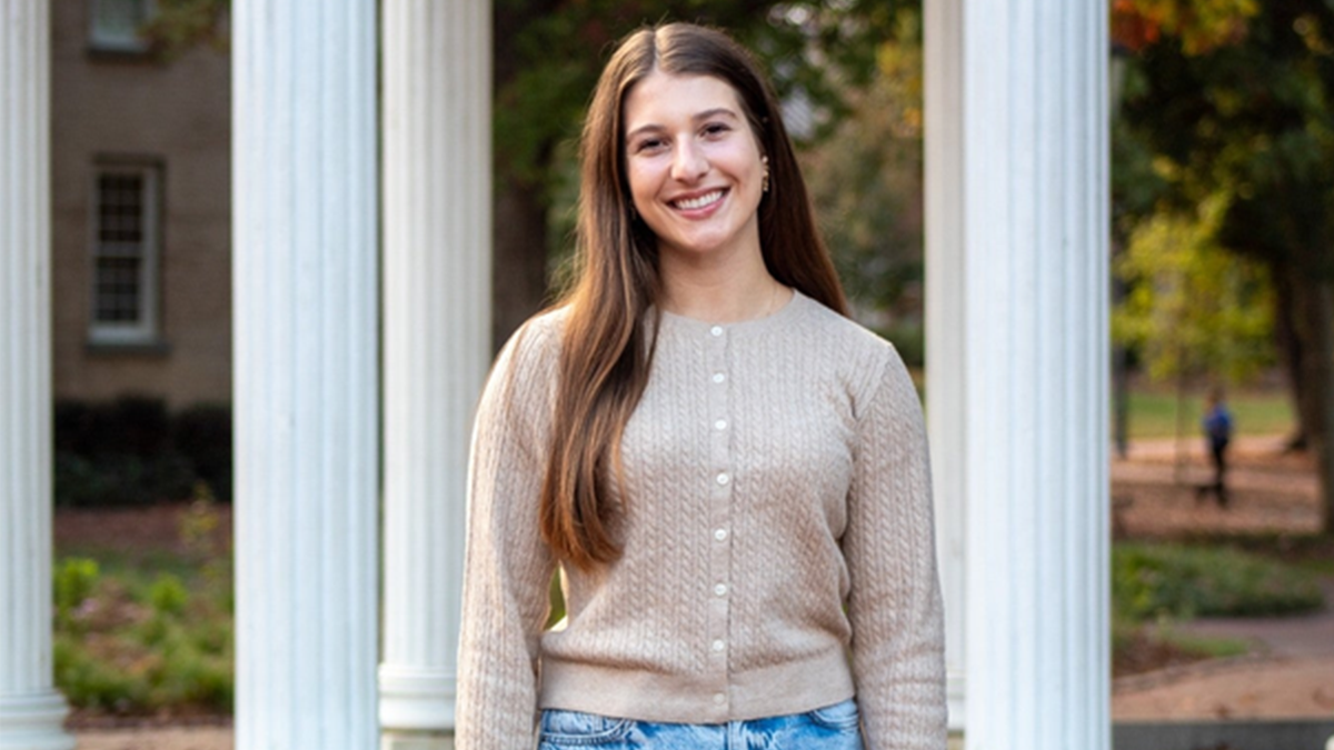 Elizabeth Kohn standing in front of Old Well.
