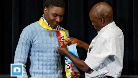 A first-generation college graduate receives a special pin during the Carolina Firsts Pinning Ceremony