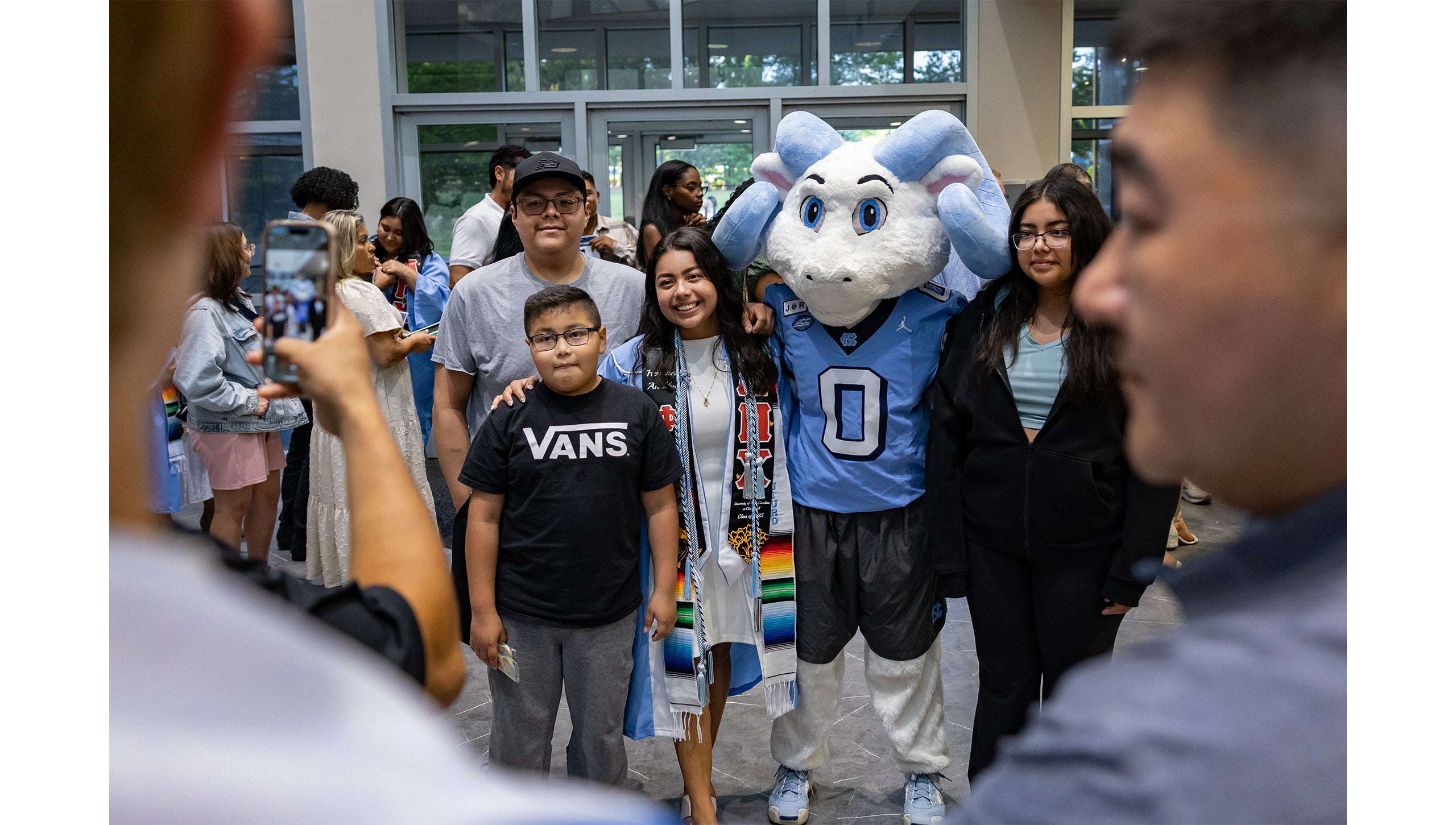 Rameses Jr. poses with a family at the Carolina Firsts Pinning Ceremony