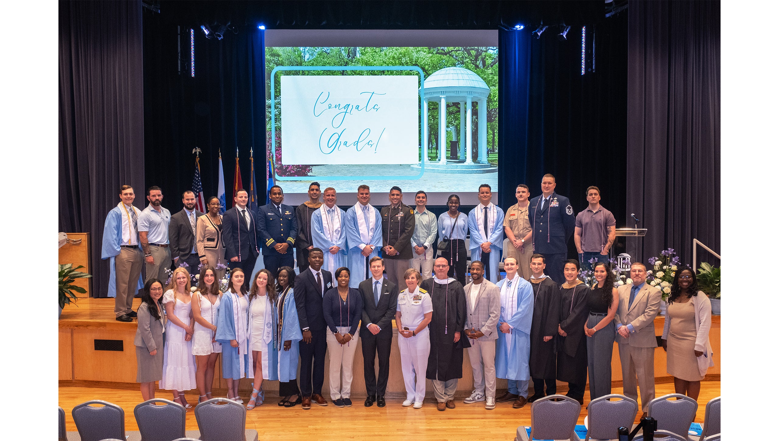 Graduates pose together at the Red, White and Carolina Blue Graduation