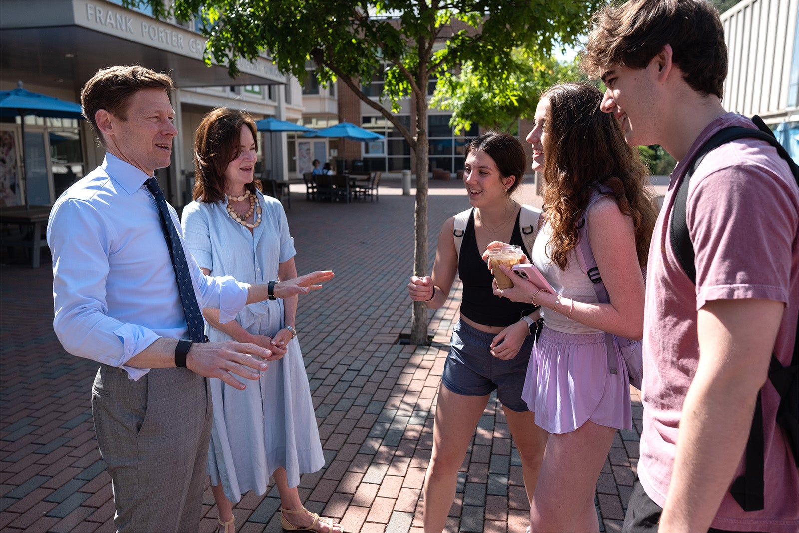 Chancellor Lee H. Roberts and his wife Liza speak with students as they hand out coffee in the Pit.