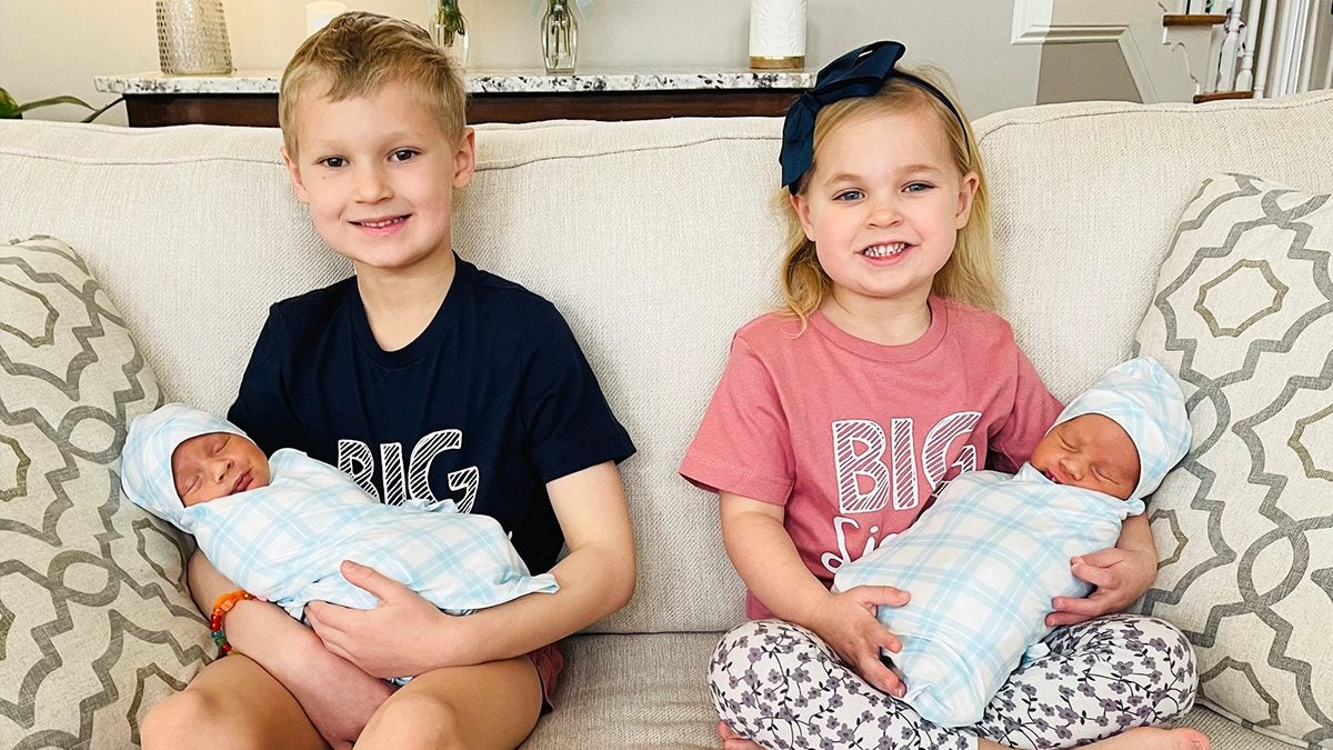 Two children holding baby siblings.