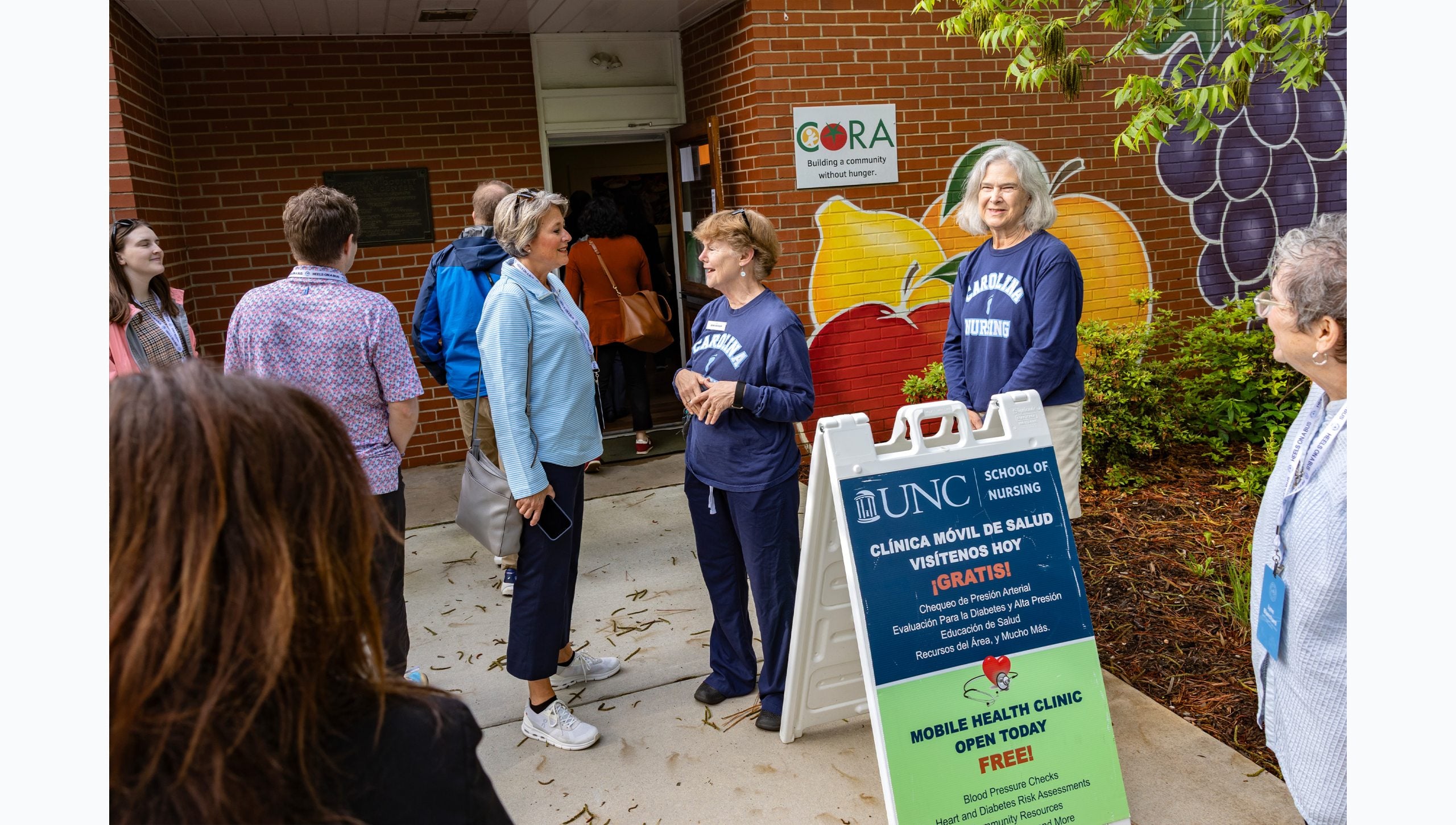 Tar Heel Bus Tour attendees congregating outside a food pantry and nursing clinic.