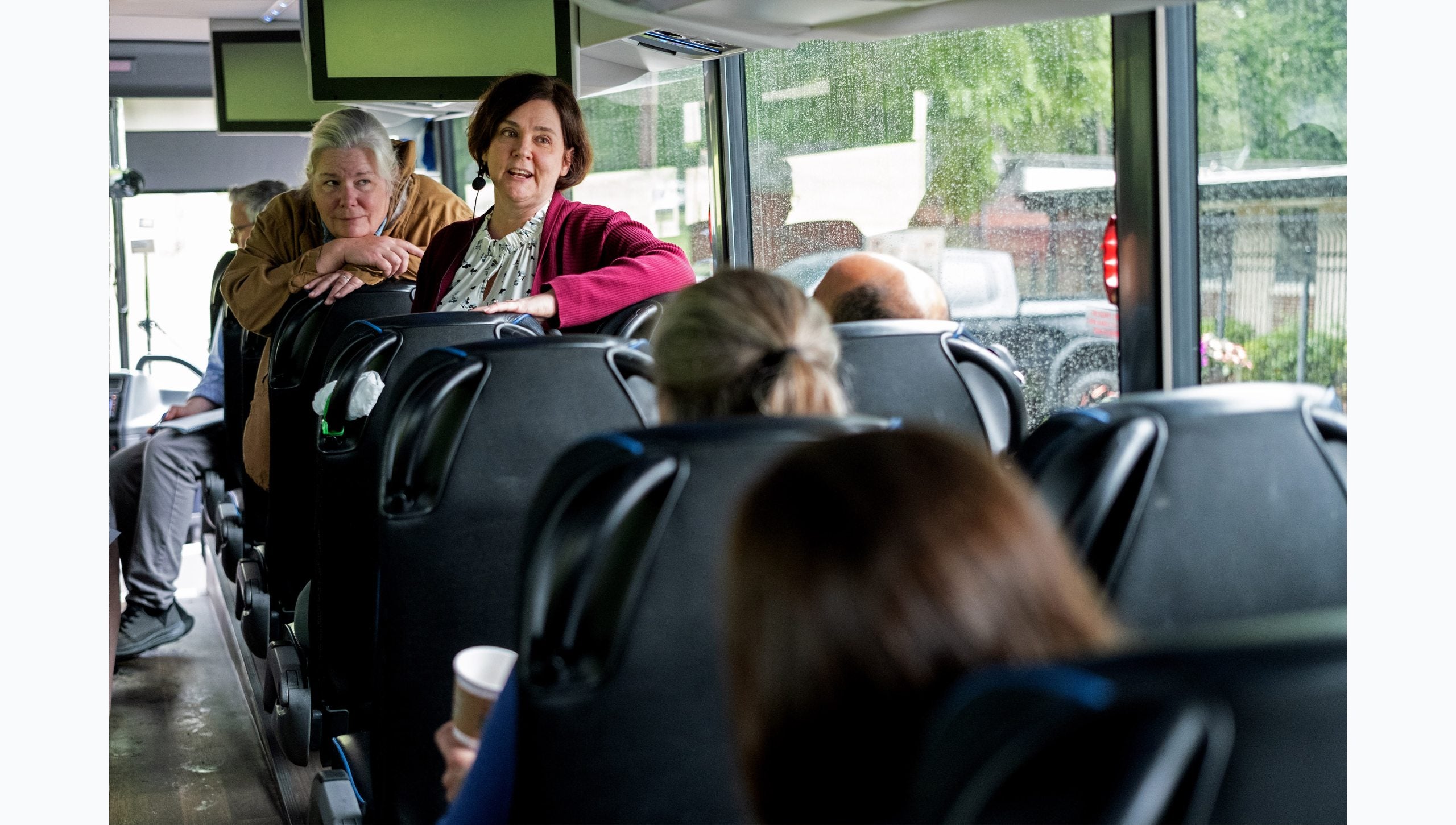 Tar Heel Bus Tour participants talking to each other onboard the West bus.