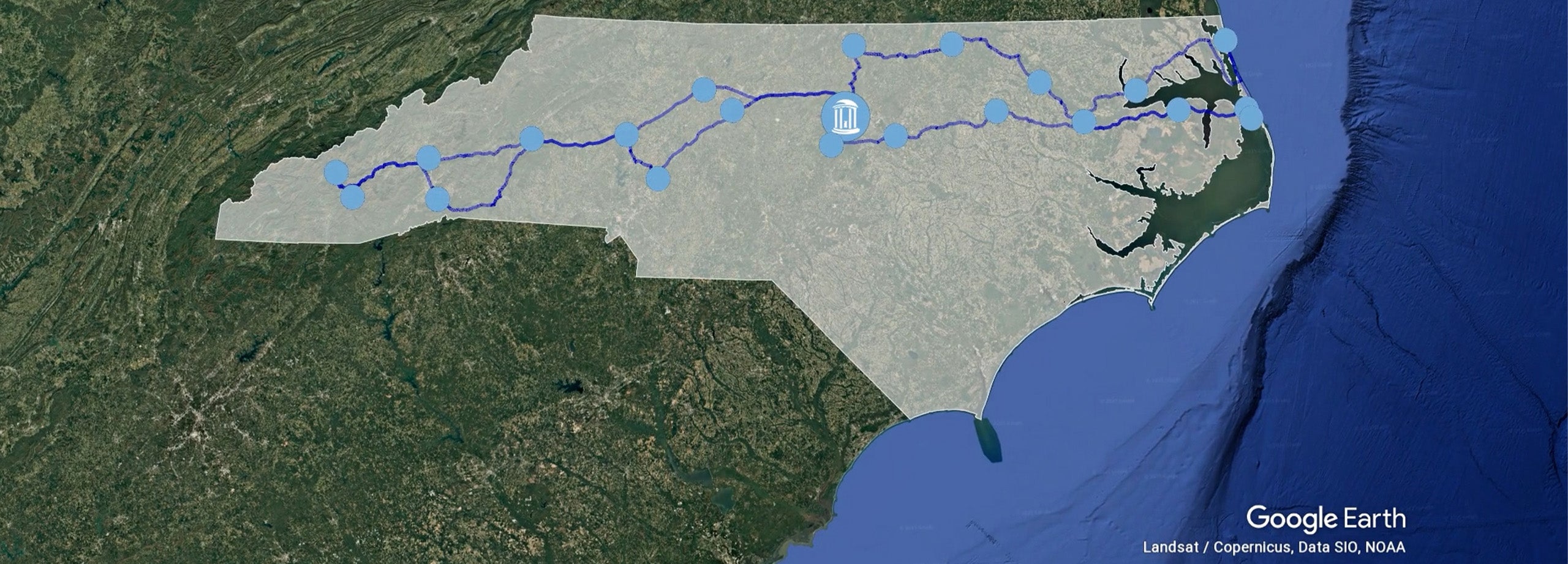 Google Earth map of the Tar Heel Bus Tour stops spread across North Carolina with Old Well logo atop Chapel Hill to represent UNC-Chapel Hill.