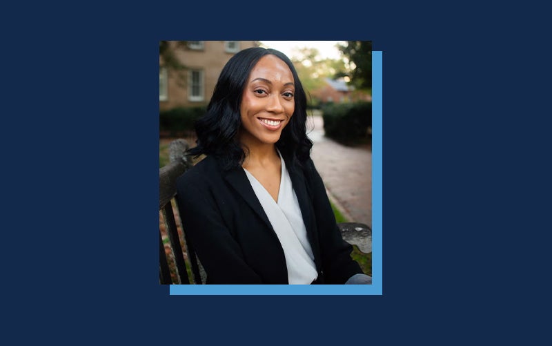 Portrait of Aleah Bailey atop a Navy blue background.