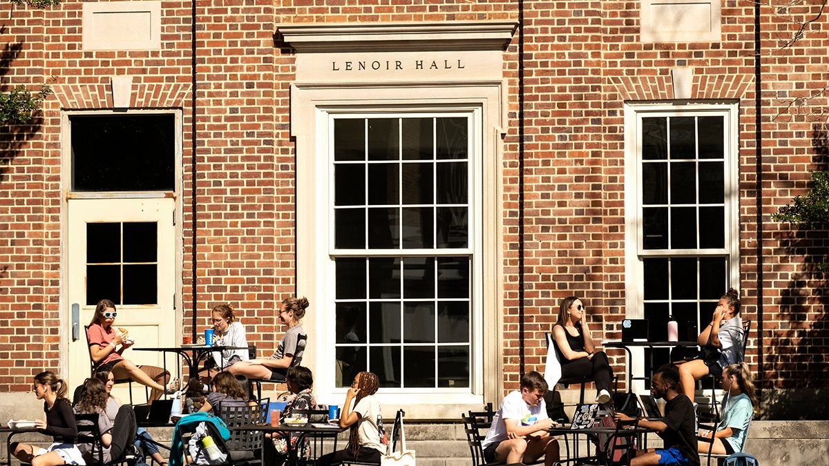Students sit outside Lenoir Hall