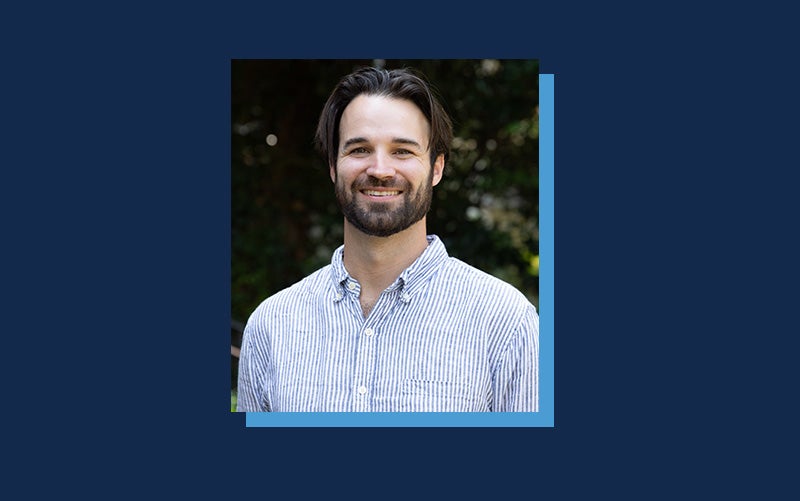 Portrait of Nick Funnell atop a Navy blue background.