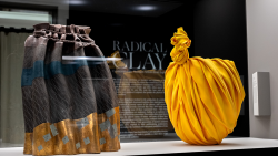 Two ceramic pieces encased in front of text reading 