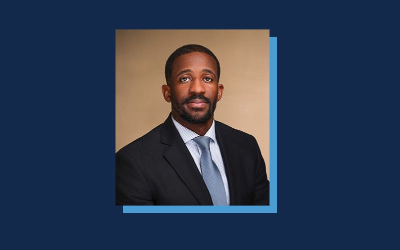 Portrait of Kenneth Harris atop a Navy blue background.