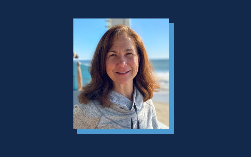 Portrait of Jennifer Stone atop a Navy blue background.