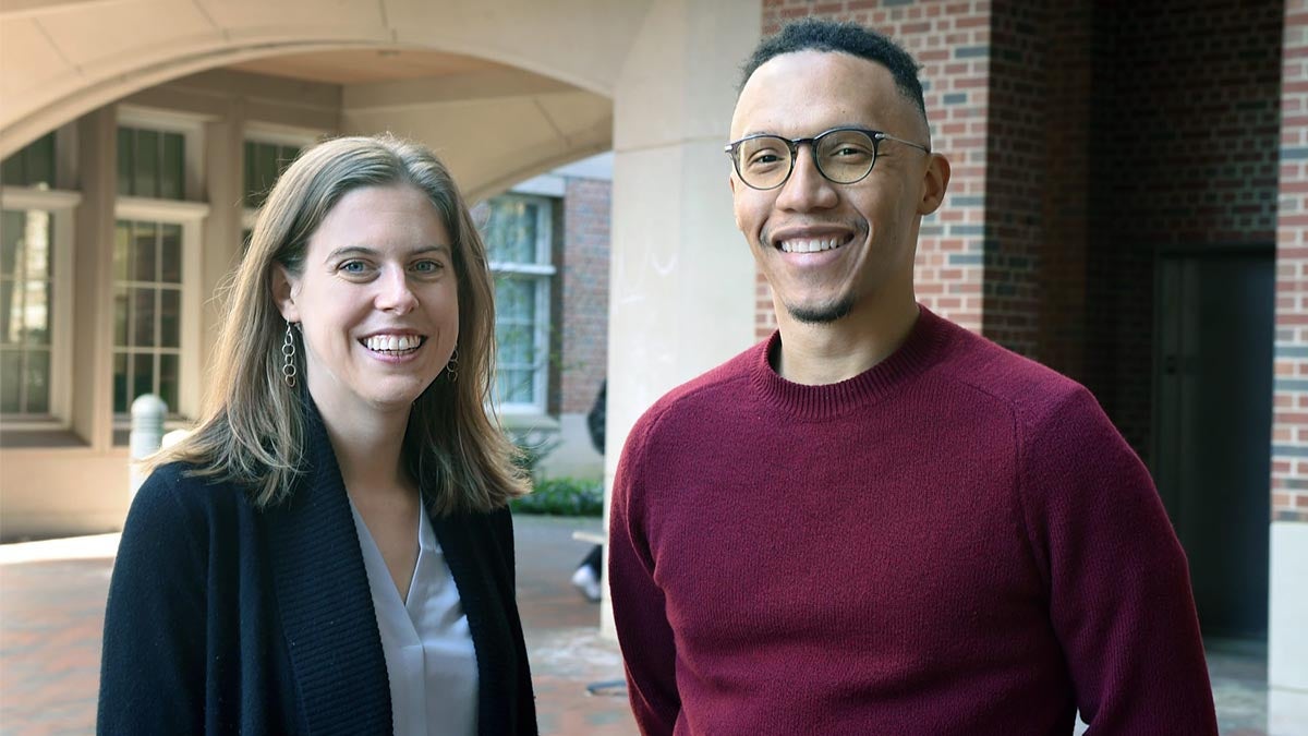 Abigail Knight and Sidney Wilkerson-Hill pose in front of brick building.