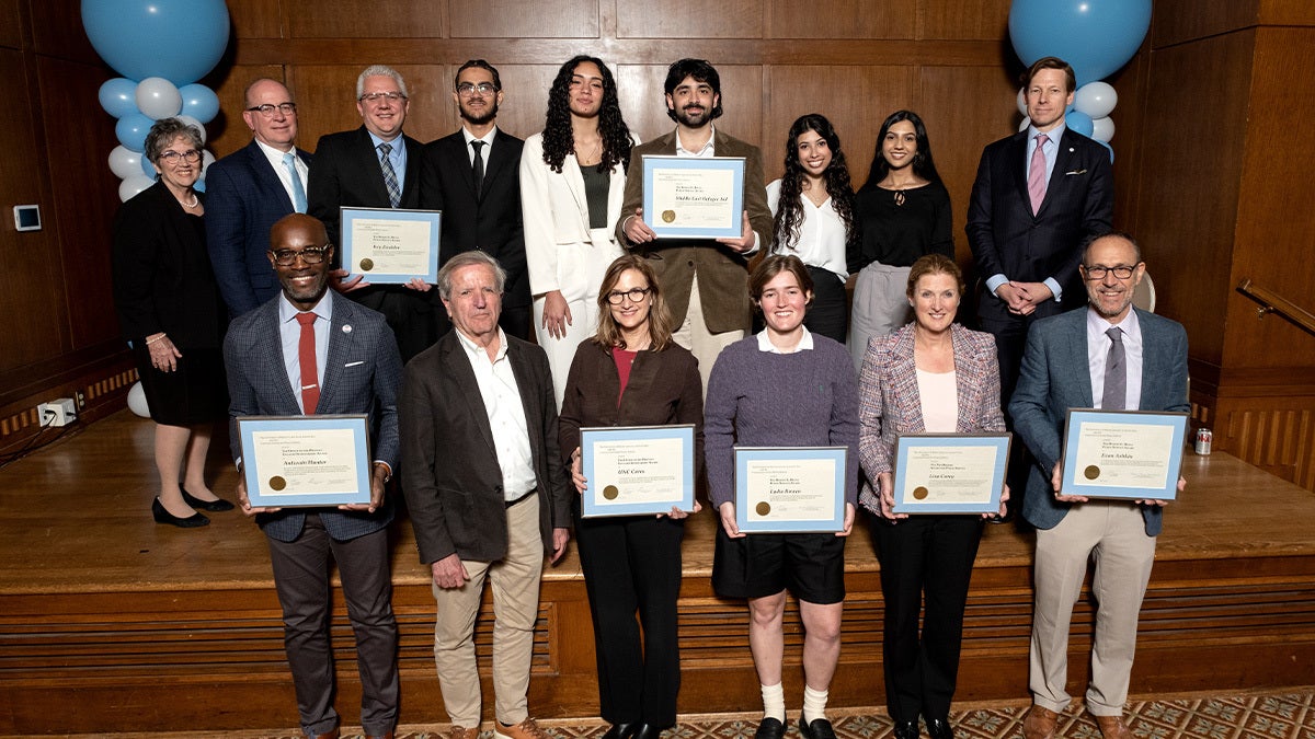 Interim Chancellor Roberts standing at the top right alongside a row of Public Service award winners.