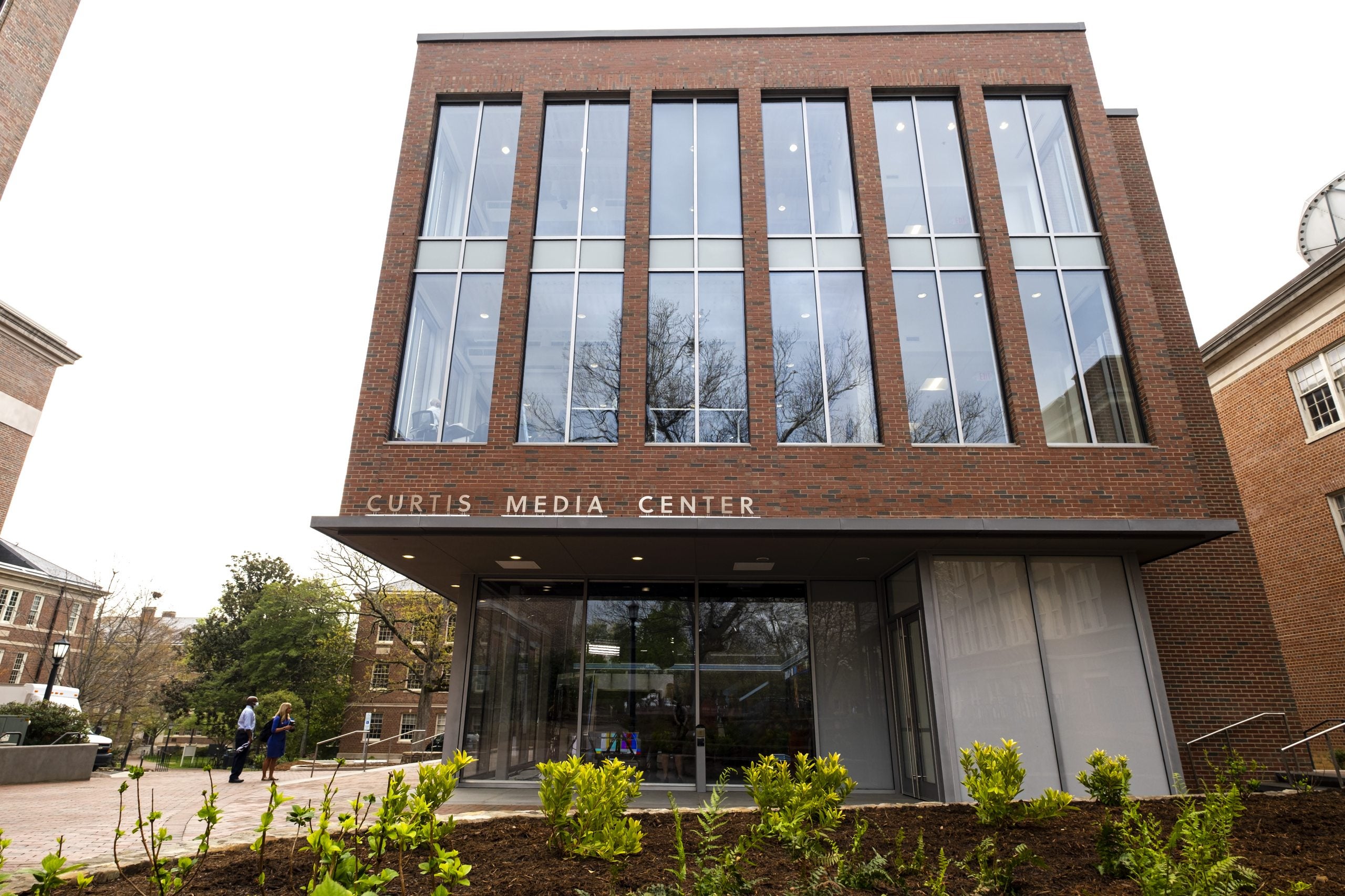 Exterior of Curtis Media Center with plants seen in the foreground on the campus of UNC-Chapel Hill.